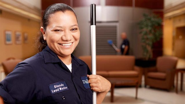 Woman at her job at a federal job site where she works through Didlake's Custodial Contract Services.