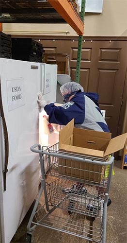 Volunteer with Didlake's Day Support Program working at food pantry in Northern Virginia.